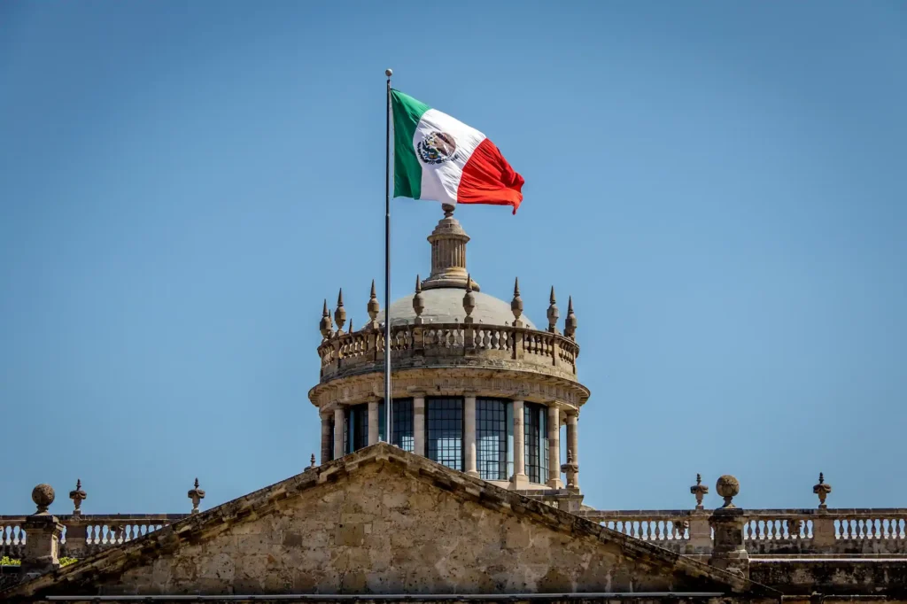 Bandera de México ondeando sobre edificio histórico